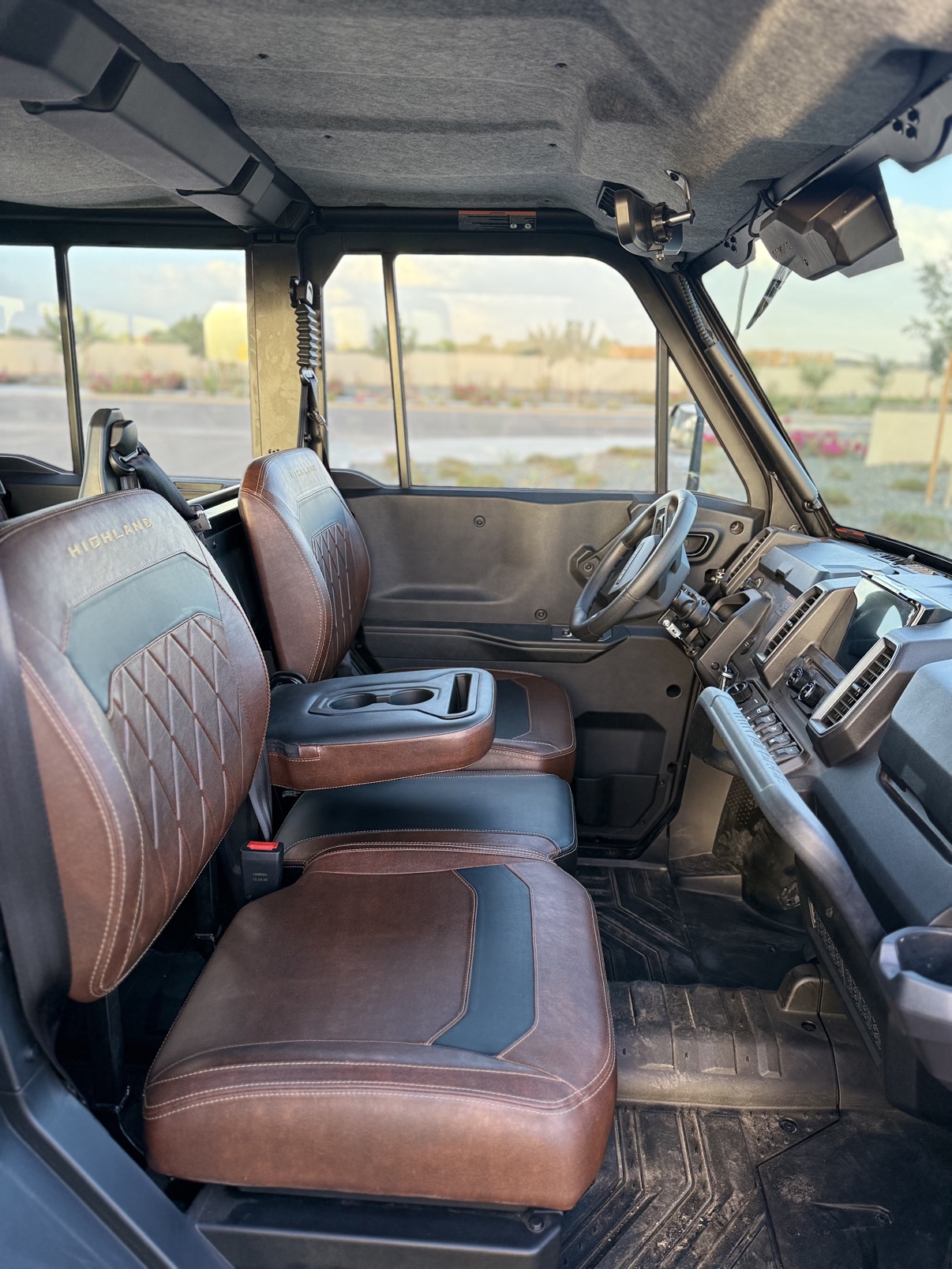 Front seats and dashboard viewed from the rear door of the enclosed cab